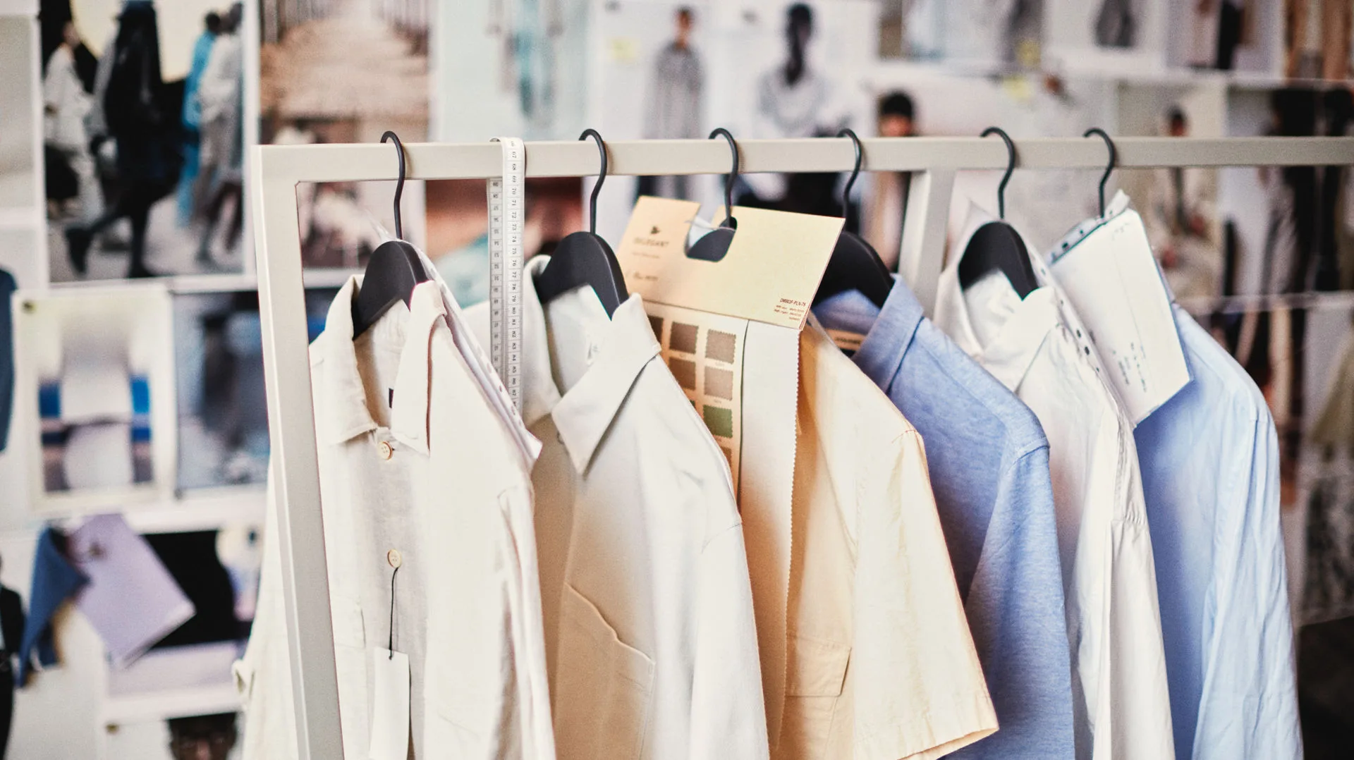 Bestseller fashion design studio with shirts on a rack and mood boards